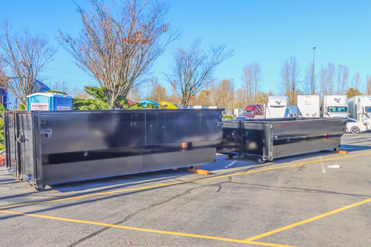 Professional dumpster rental service with roll-off container on residential driveway in North Whitehall